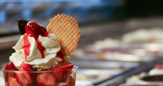 Delizioso gelato con fragole, panna e cialda croccante.